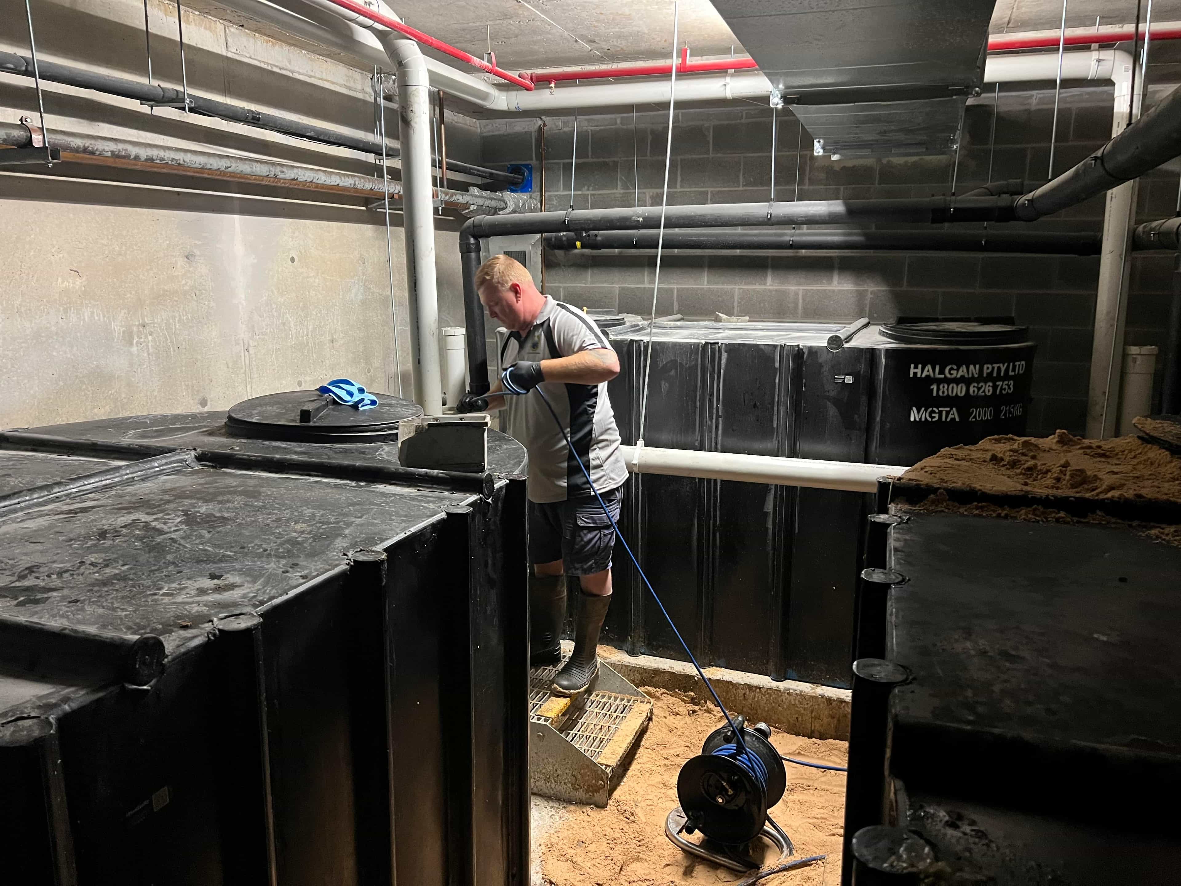 Commercial drainage access area with pipework and work equipment
