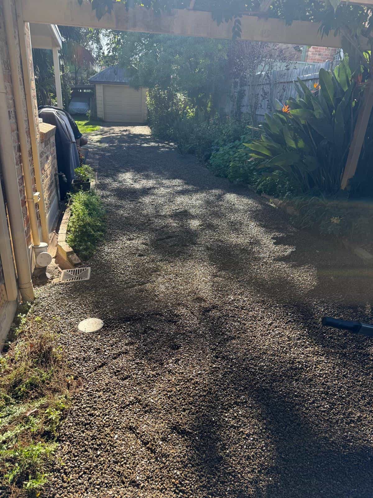 Finished gravel drainage area beside a home