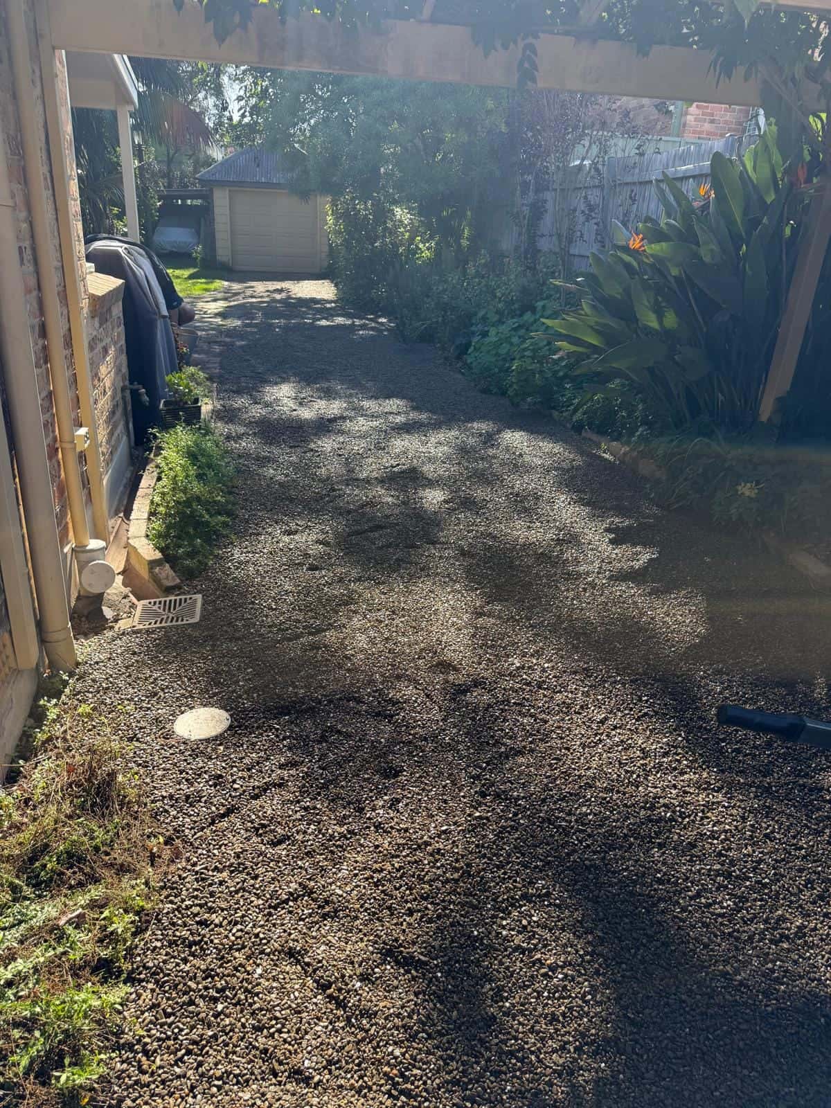 Finished gravel drainage area beside a home