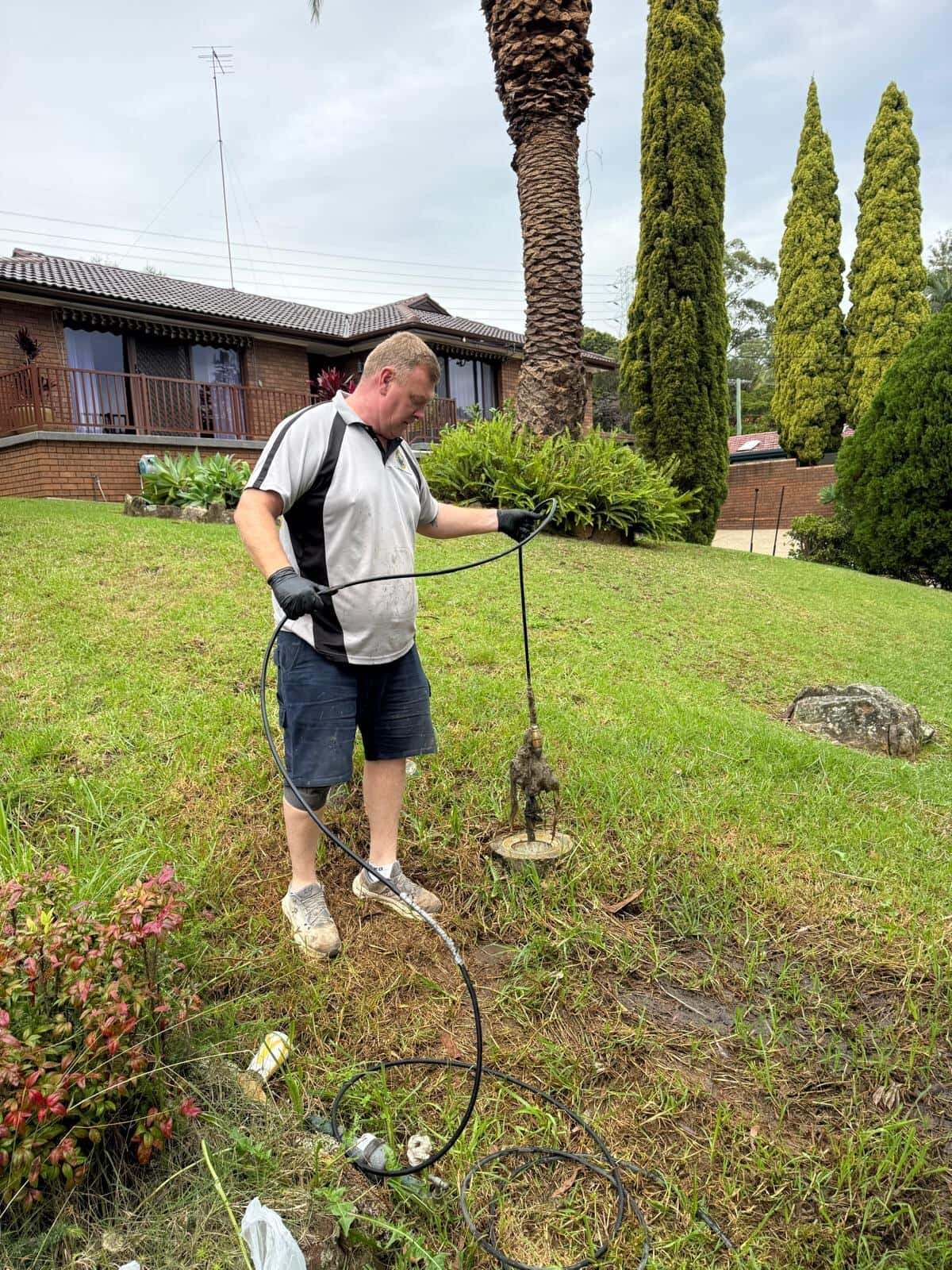Scott Johnstone clearing an outdoor drain line at a Sydney home