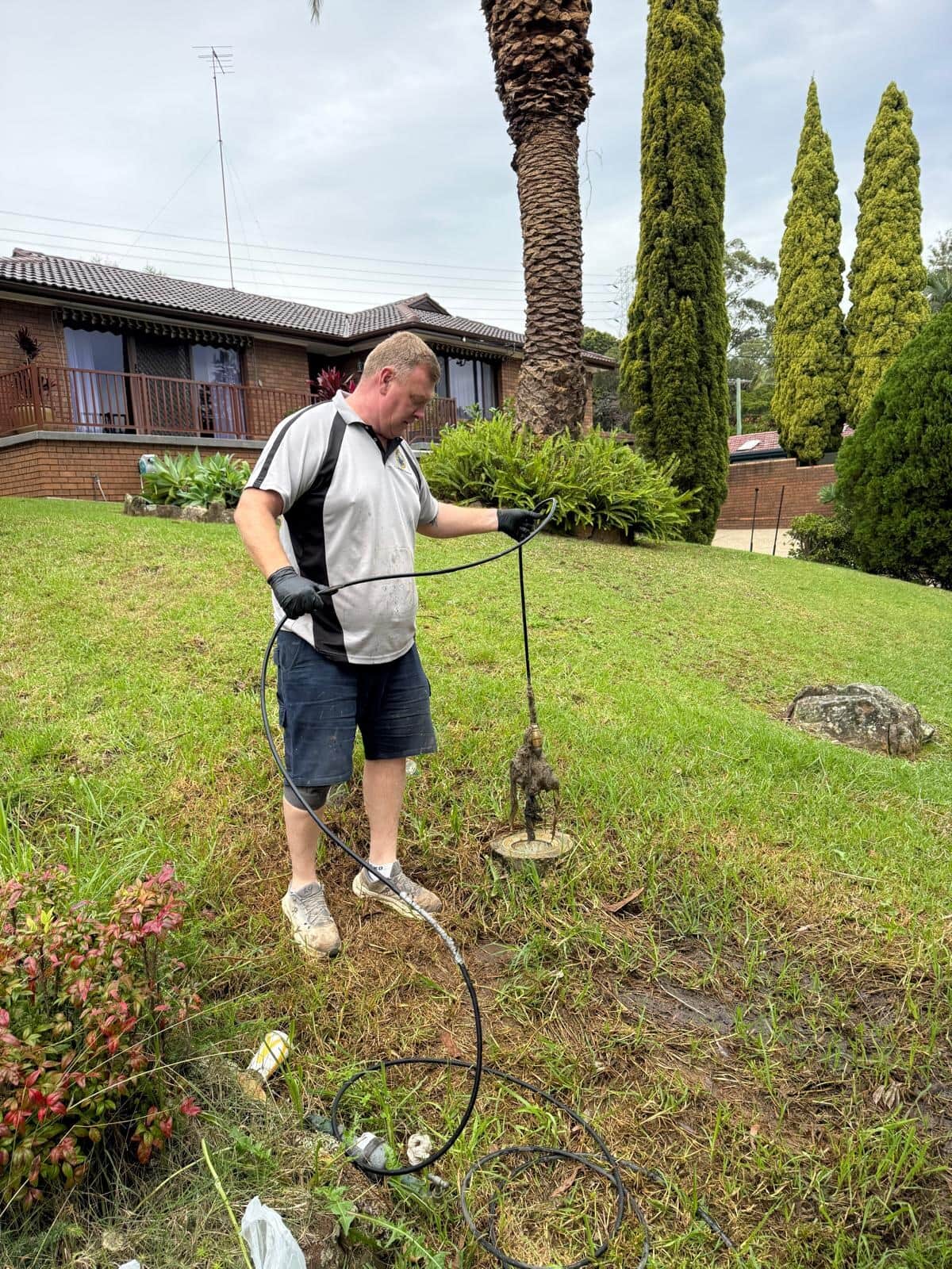 Scott Johnstone clearing an outdoor drain line at a Sydney home