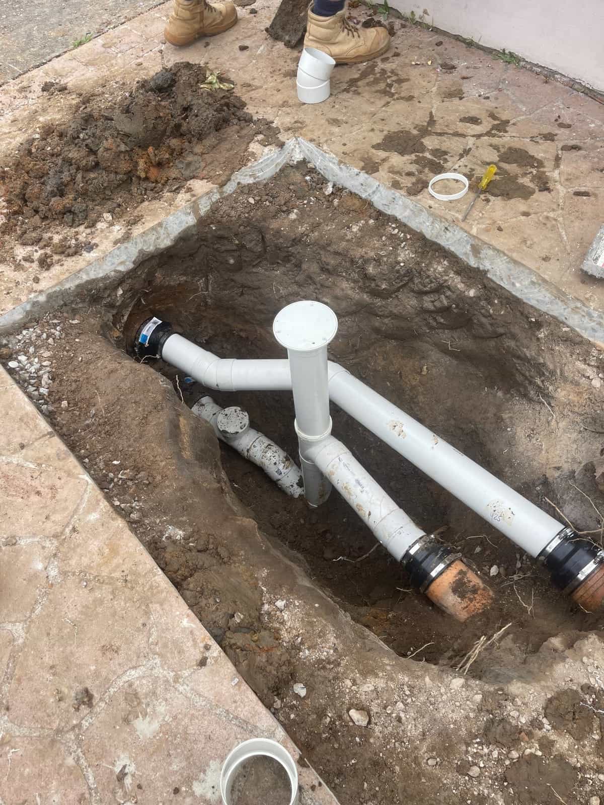 New stormwater pipework installed in a narrow trench