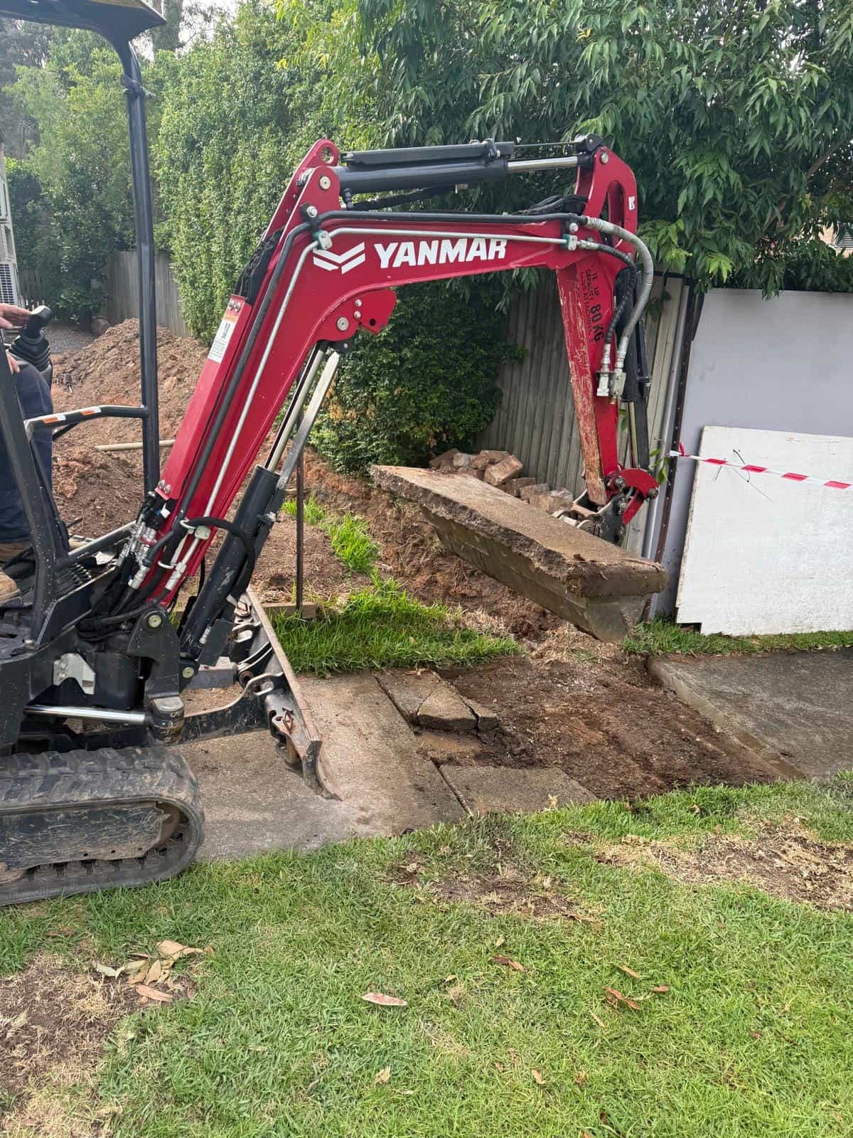 Small excavator used for outdoor drainage access