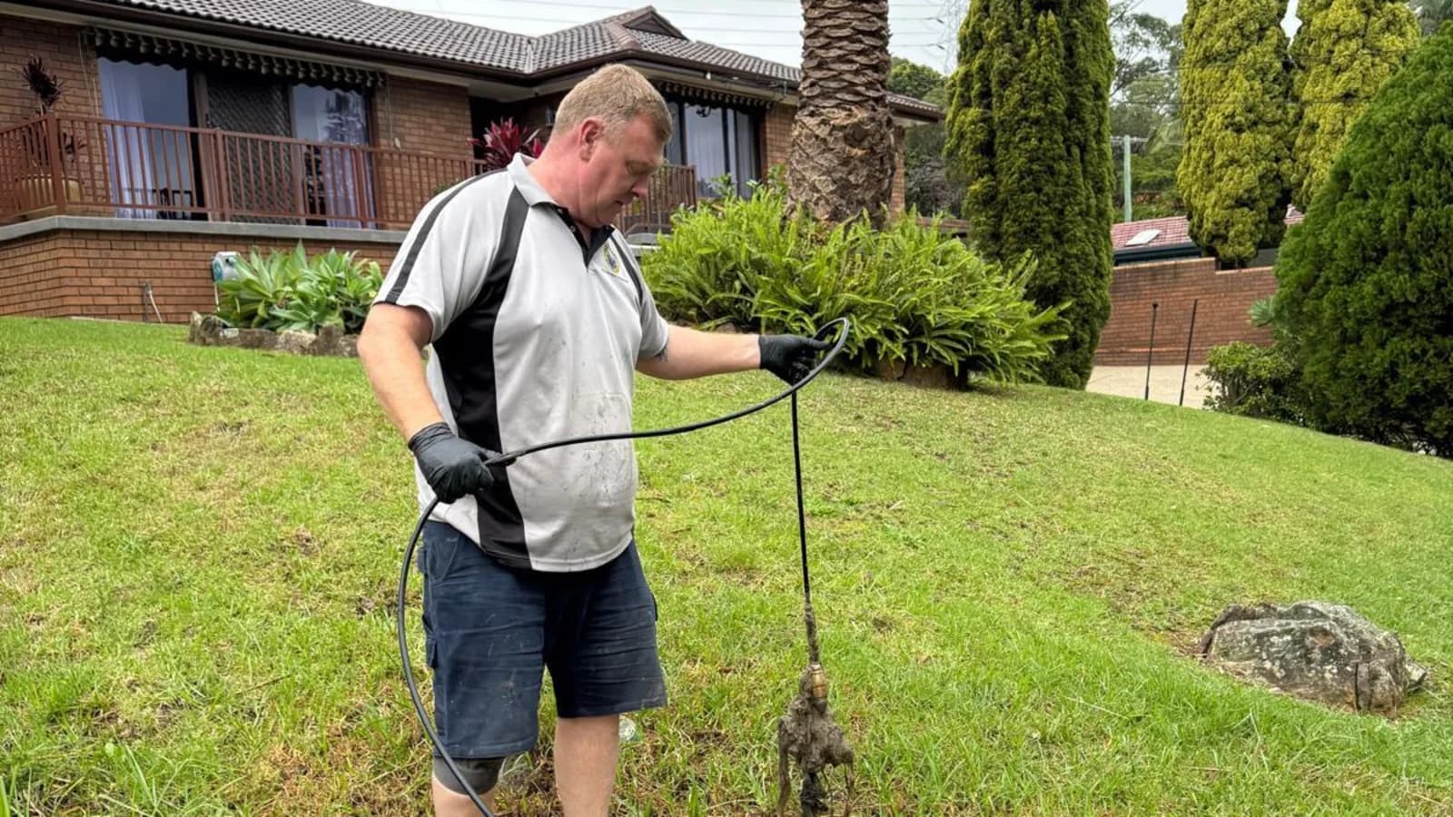 Scott Johnstone clearing an outdoor drain line at a Sydney home