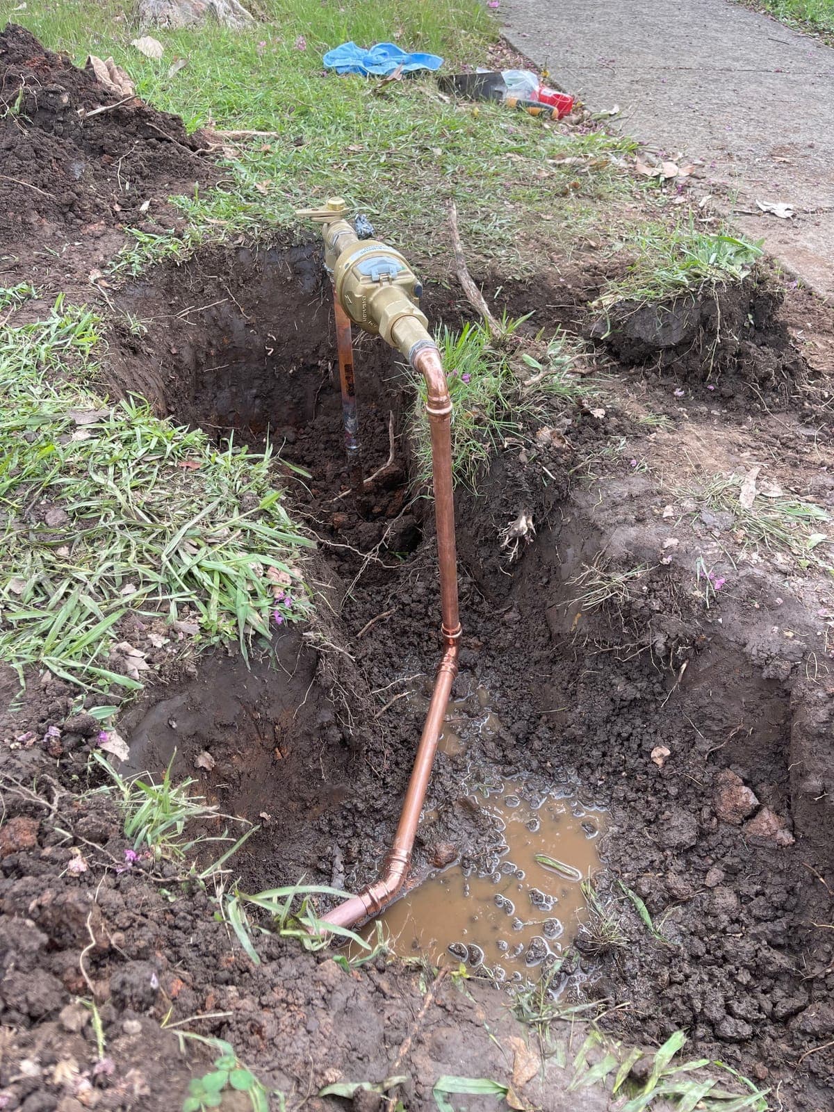 Drain clearing equipment connected near an exposed pipe access point