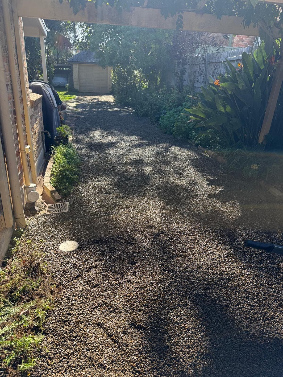 Finished gravel drainage area beside a home