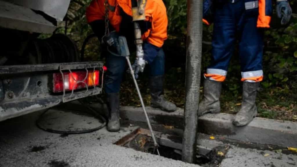 Night drain callout equipment beside an open outdoor drain access