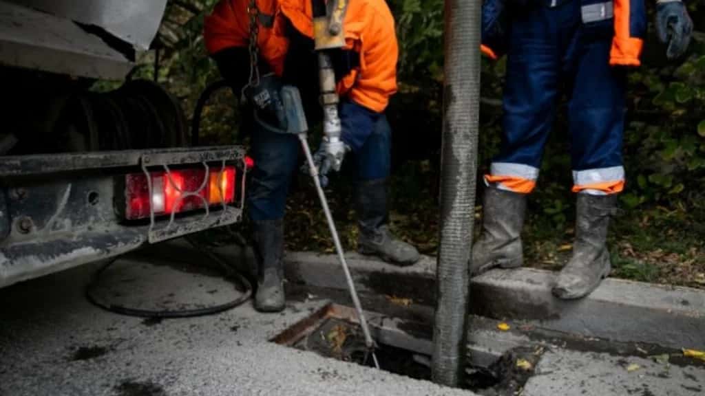 Night drain callout equipment beside an open outdoor drain access