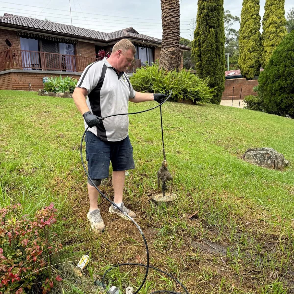 Scott Johnstone clearing an outdoor drain line at a Sydney home